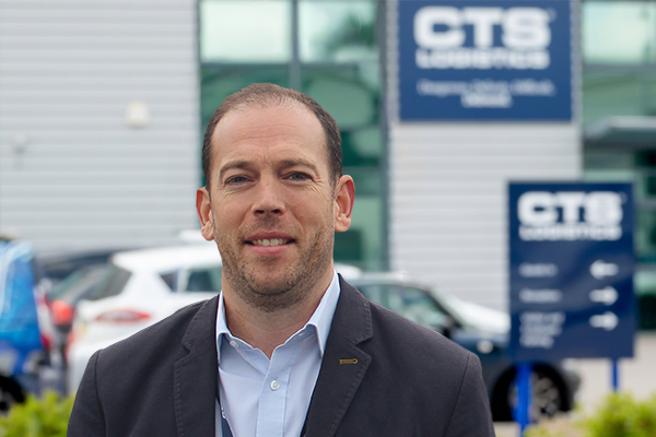 Bright head and shoulders photo of Jonathan Monks CTS Logistics Regional Director in front of CTS head office